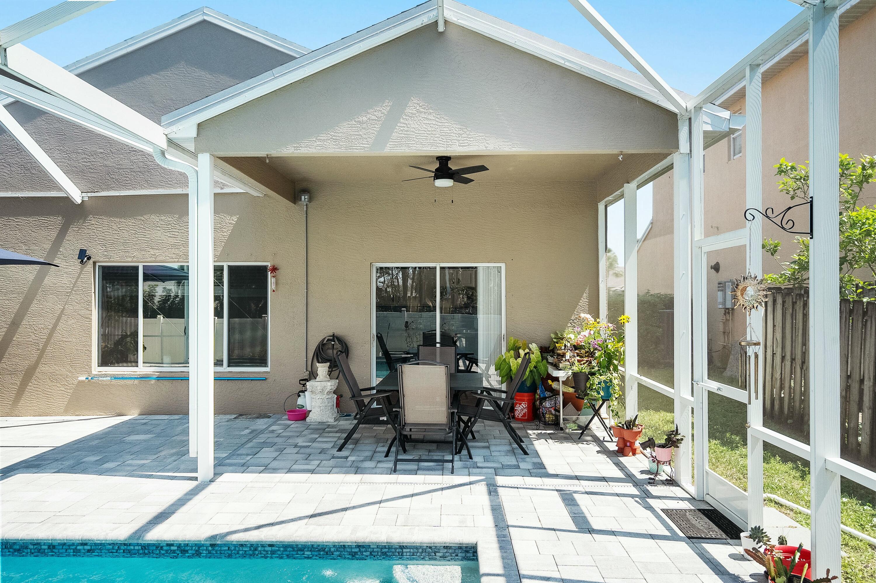 2480 Southeast Springtree Place Stuart, FL 34997 - Photo 31 of 39 a front view of a house with outdoor seating