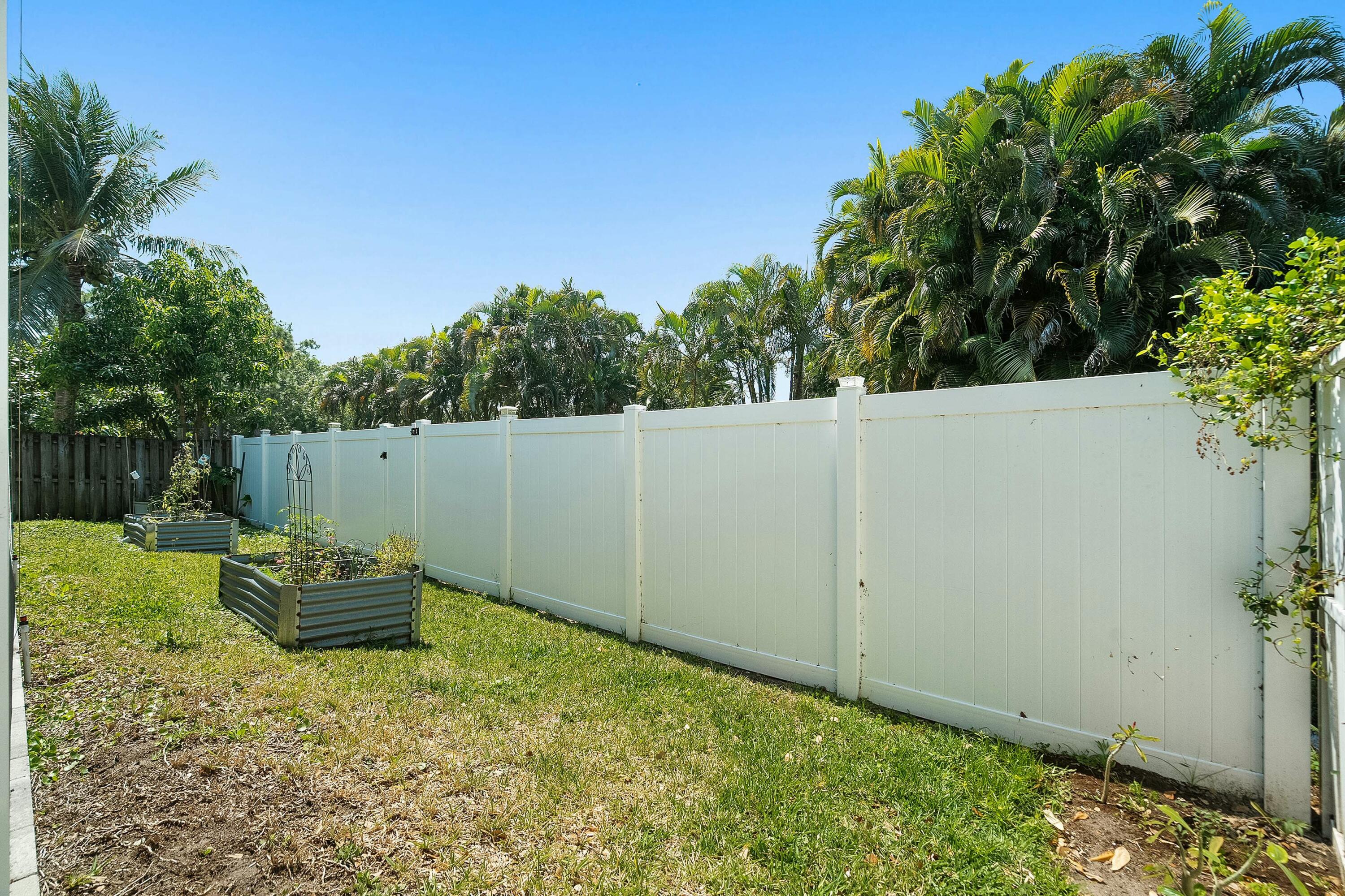 2480 Southeast Springtree Place Stuart, FL 34997 - Photo 34 of 39 a backyard of a house with a tree