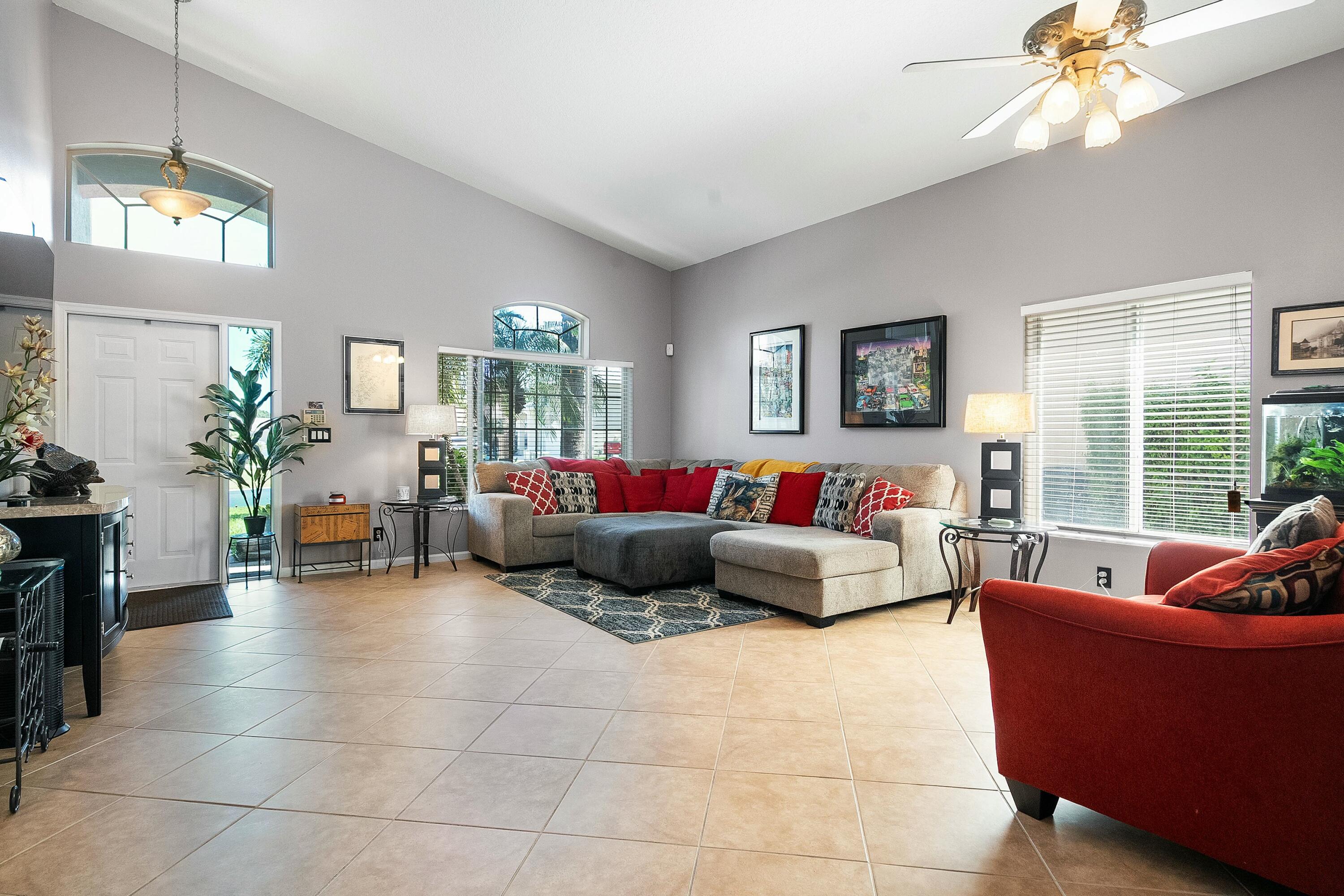 2480 Southeast Springtree Place Stuart, FL 34997 - Photo 5 of 39 a living room with furniture and a chandelier
