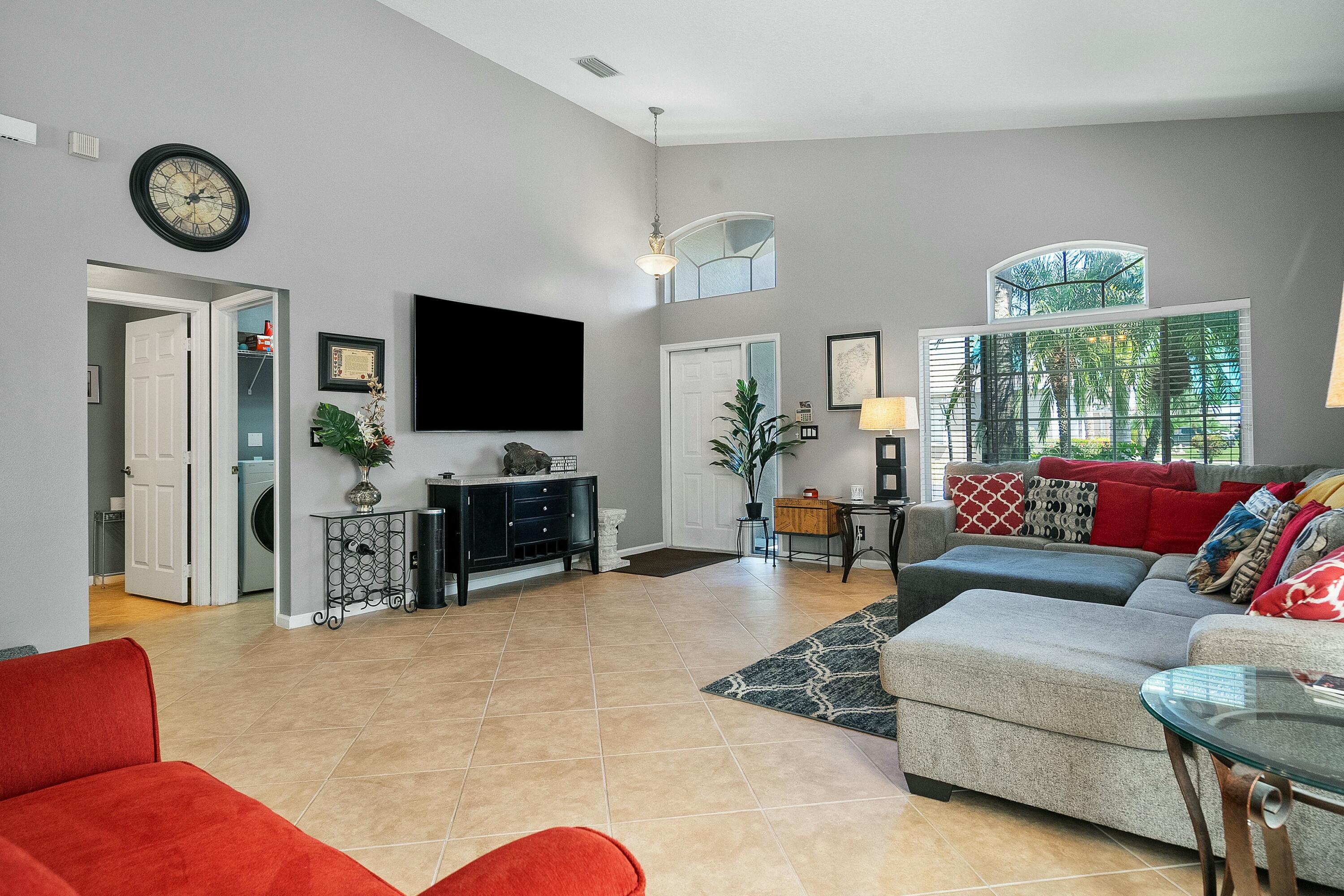 2480 Southeast Springtree Place Stuart, FL 34997 - Photo 6 of 39 a living room with furniture and a flat screen tv