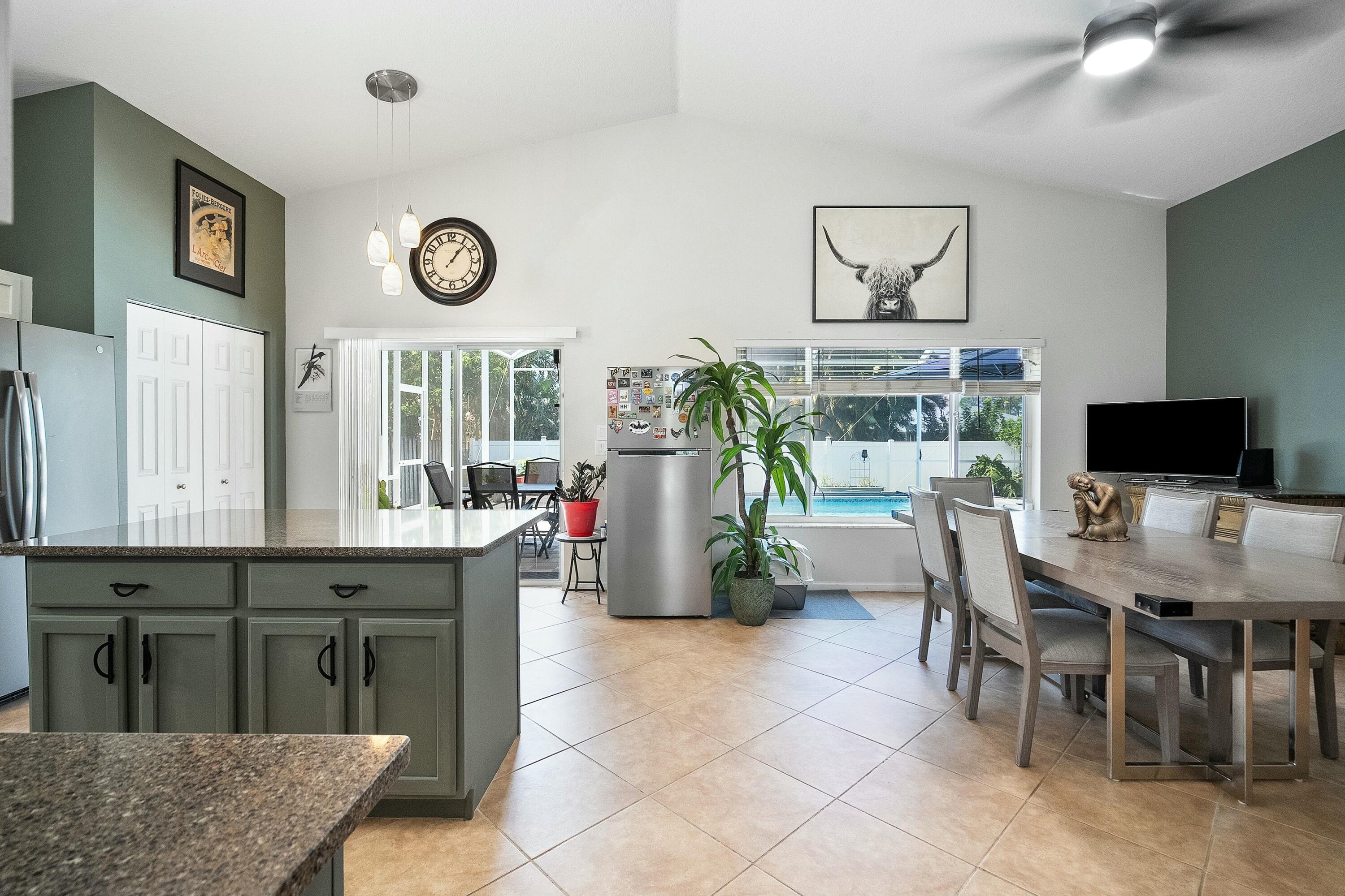 2480 Southeast Springtree Place Stuart, FL 34997 - Photo 7 of 39 a kitchen with a table and chairs in it