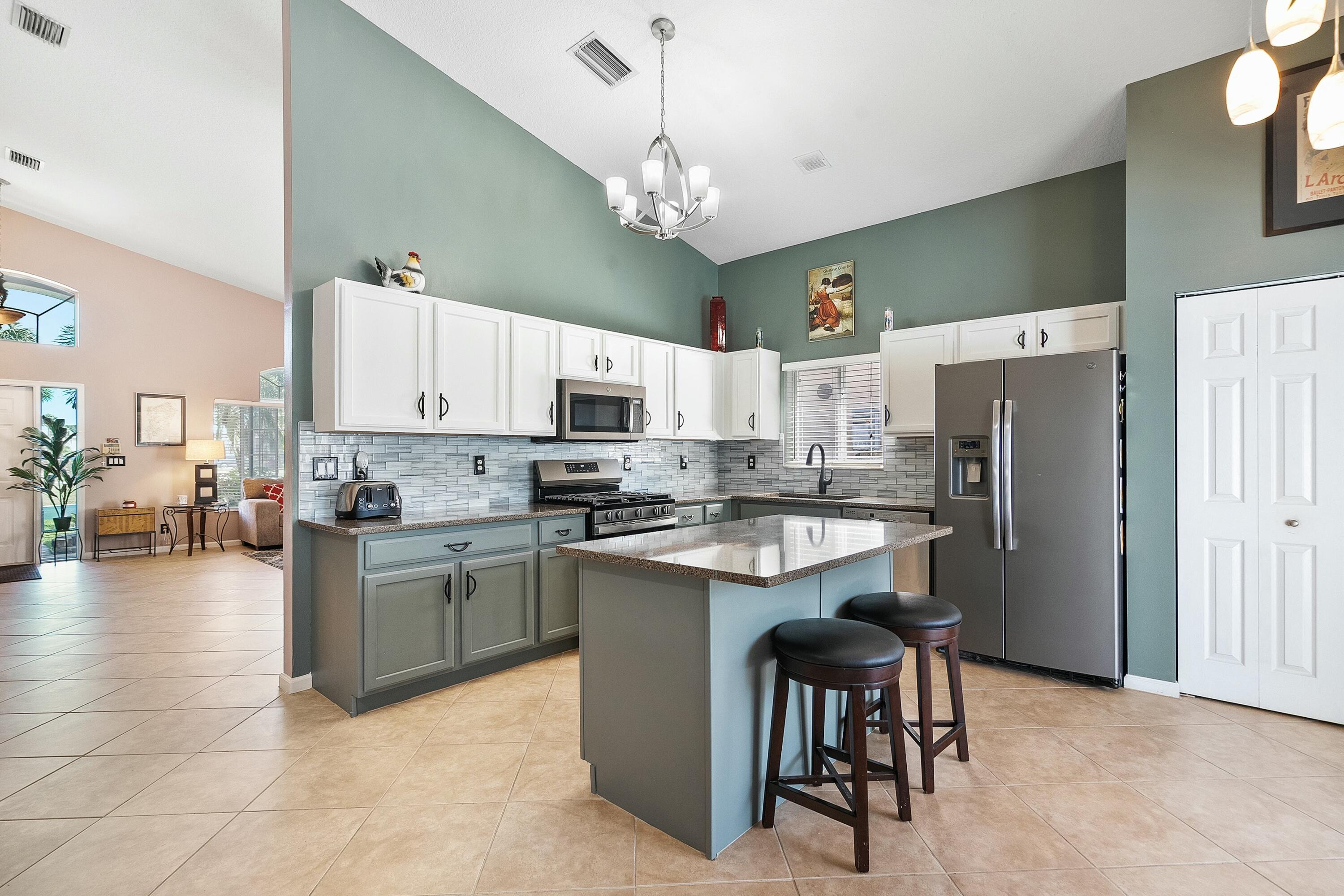 2480 Southeast Springtree Place Stuart, FL 34997 - Photo 8 of 39 a kitchen with cabinets and stainless steel appliances