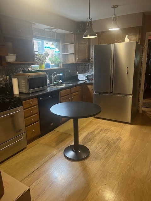 6147 North Harding Avenue Chicago, IL 60659 - Photo 3 of 10 a kitchen with counter top space cabinets and stainless steel appliances