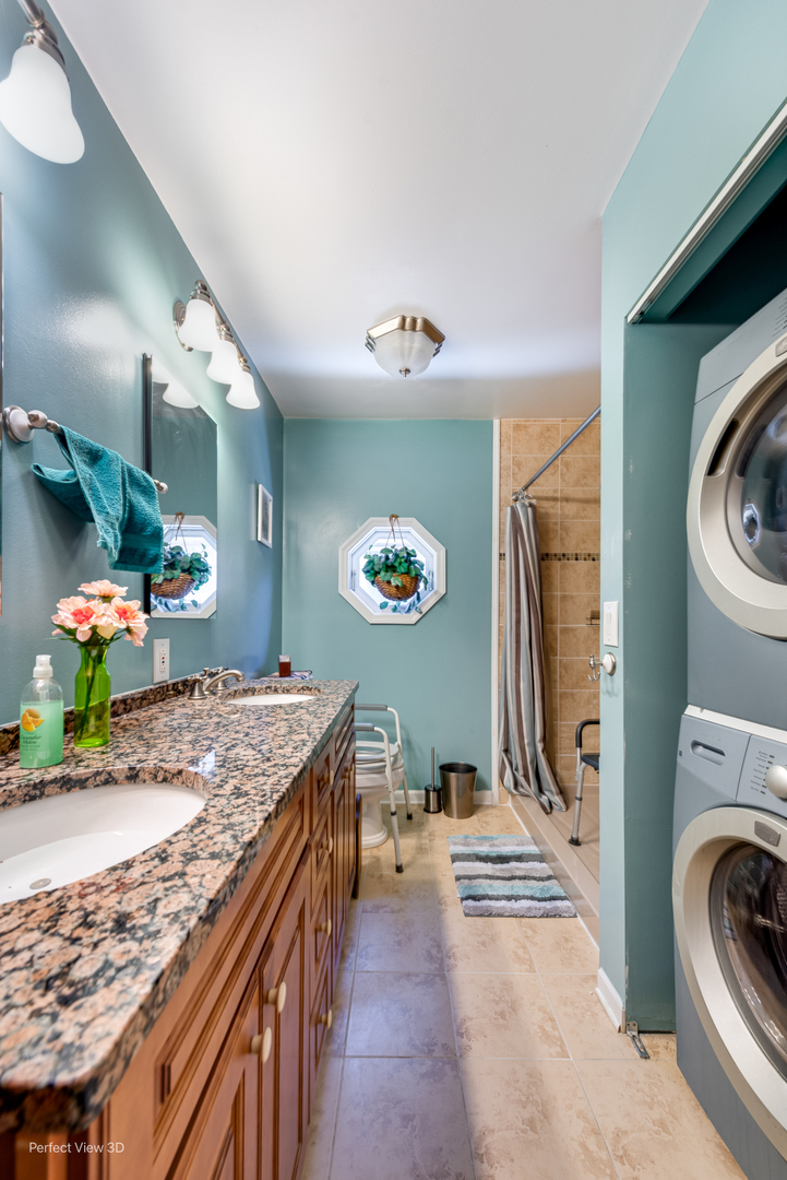6147 North Harding Avenue Chicago, IL 60659 - Photo 4 of 10 a view of a kitchen with a sink a washer and dryer