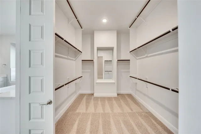 a view of a hallway with white walls and white doors