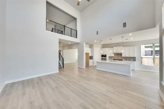 a view of kitchen with kitchen island white cabinets and stainless steel appliances