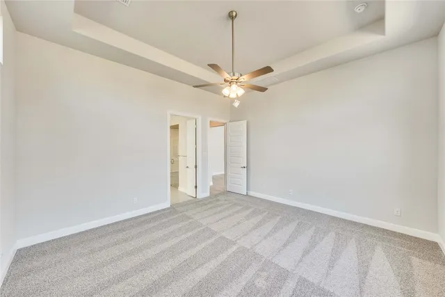 a view of an empty room with a ceiling fan