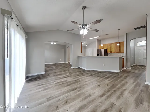 a view of a kitchen with a sink and a window