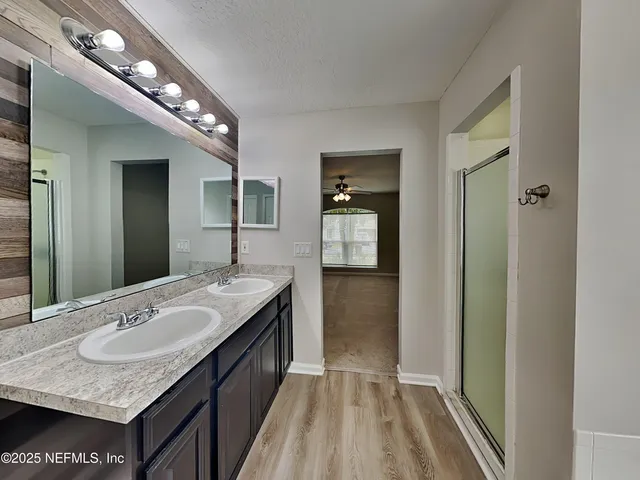 a bathroom with a sink a vanity and a mirror