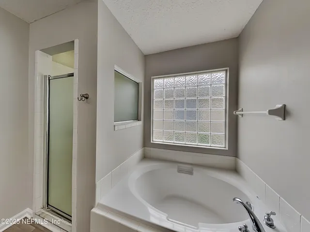 a white bath tub sitting next to a window