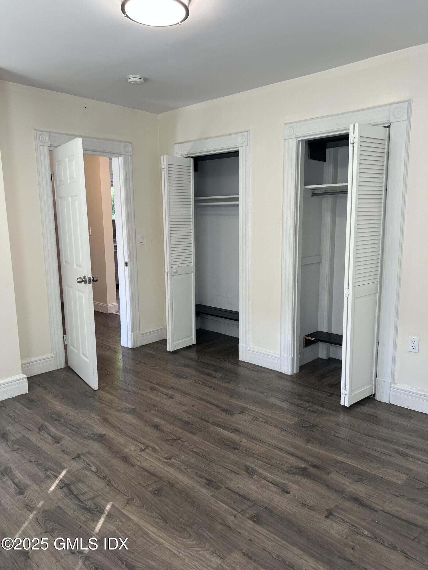 71 Byram Road, Unit 2 Greenwich, CT 06830 - Photo 4 of 10 an empty room with wooden floor and closet