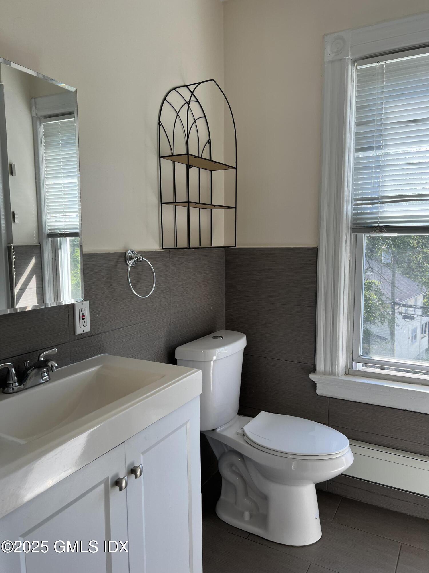71 Byram Road, Unit 2 Greenwich, CT 06830 - Photo 5 of 10 a bathroom with a toilet a sink and a window