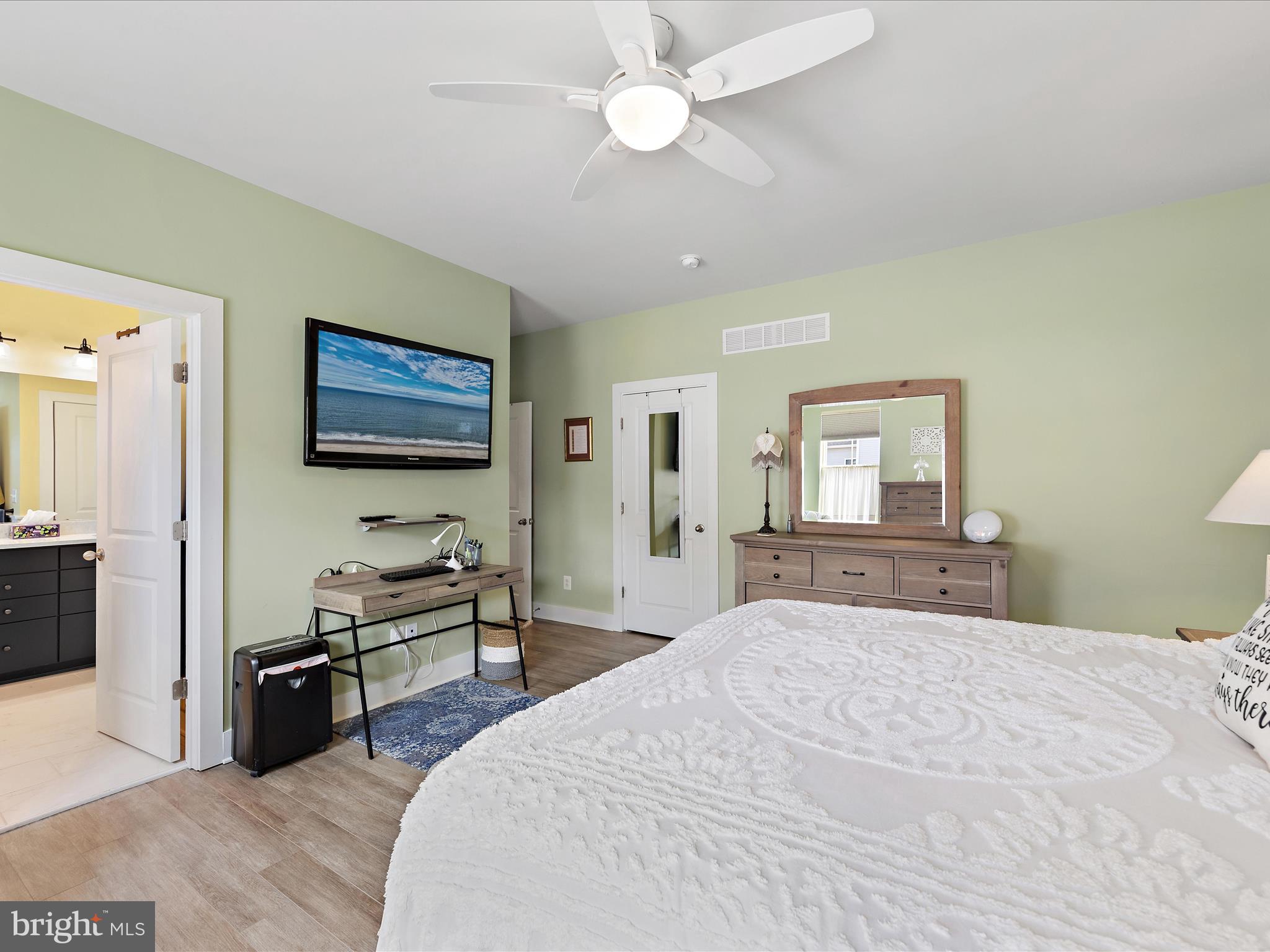 18554 Emerson Way Georgetown, DE 19947 - Photo 11 of 42 a bedroom with a bed and a flat screen tv