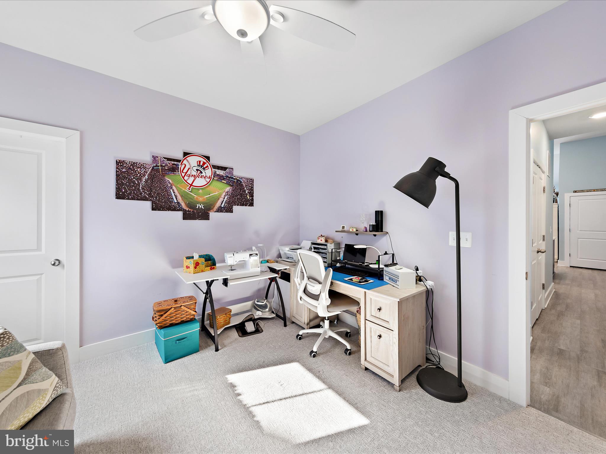 18554 Emerson Way Georgetown, DE 19947 - Photo 22 of 42 a room with furniture a rug and white walls