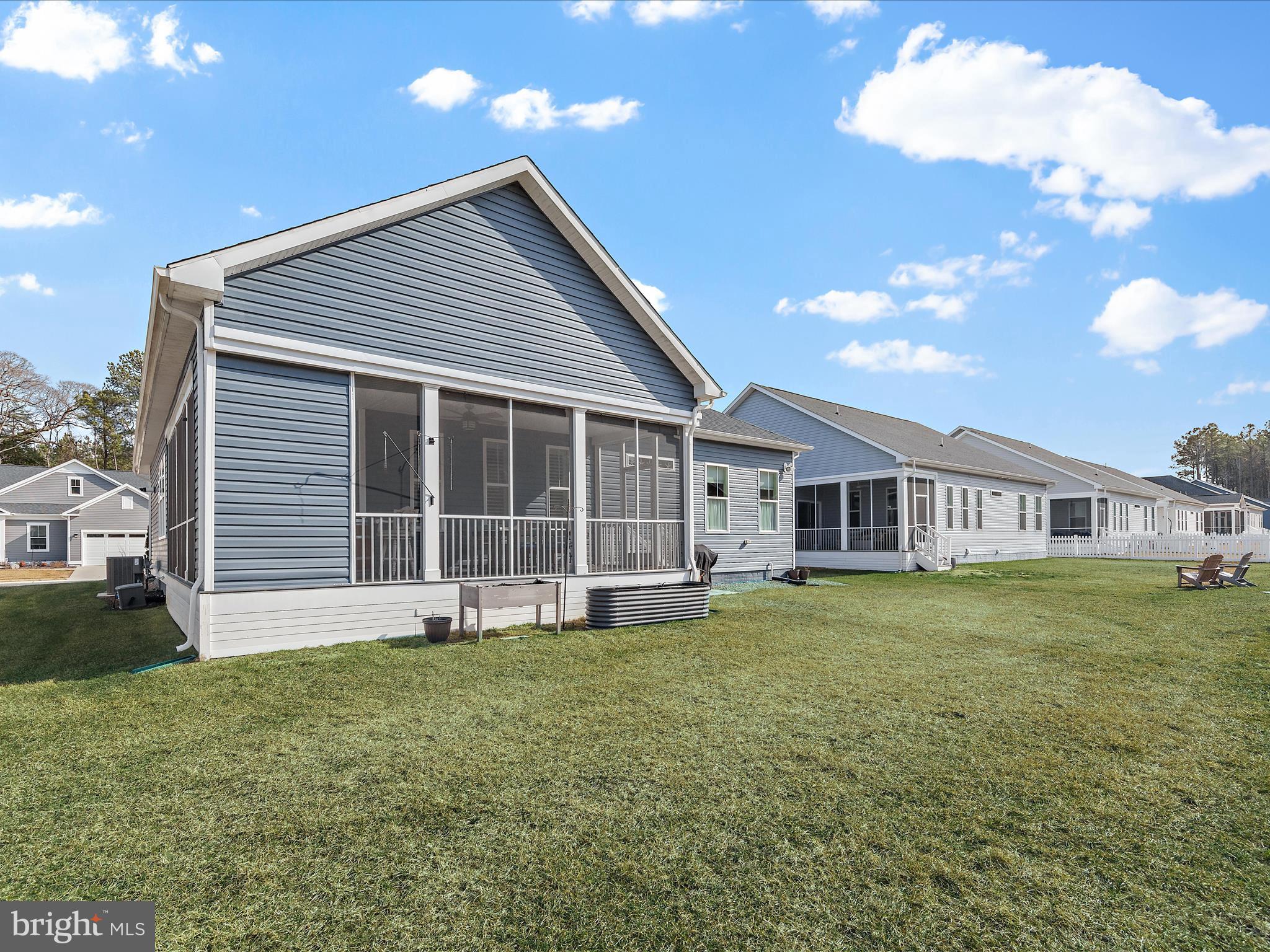 18554 Emerson Way Georgetown, DE 19947 - Photo 31 of 42 a big house with a big yard and large trees