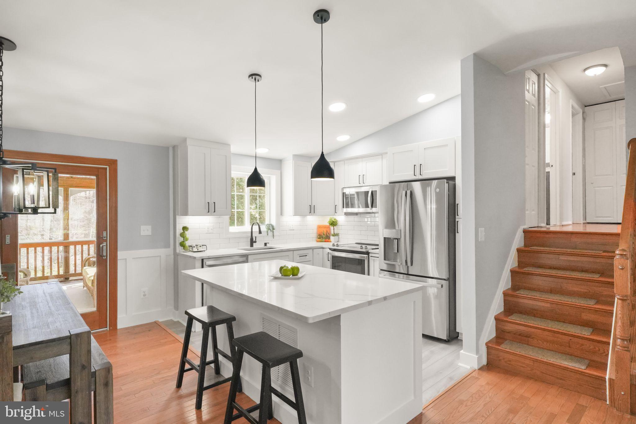8282 Morning Dew Court Springfield, VA 22153 - Photo 15 of 63 a kitchen with refrigerator a table and chairs