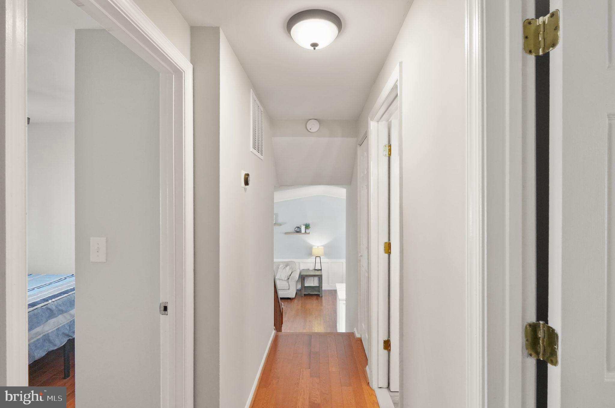 8282 Morning Dew Court Springfield, VA 22153 - Photo 25 of 63 a view of a hallway with wooden floor and staircase