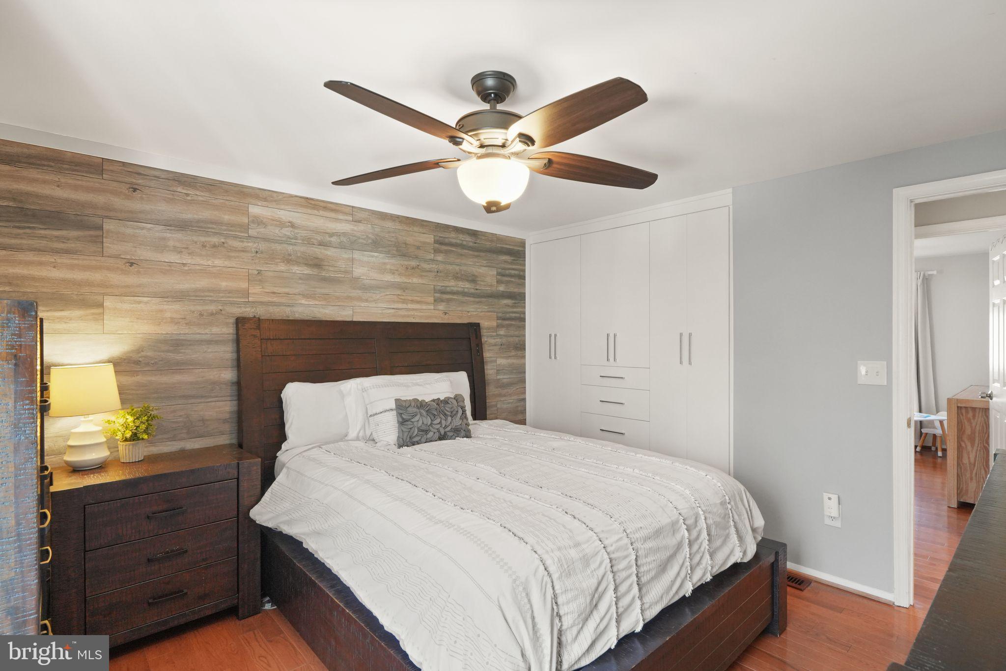 8282 Morning Dew Court Springfield, VA 22153 - Photo 27 of 63 a bedroom with a bed and a chandelier