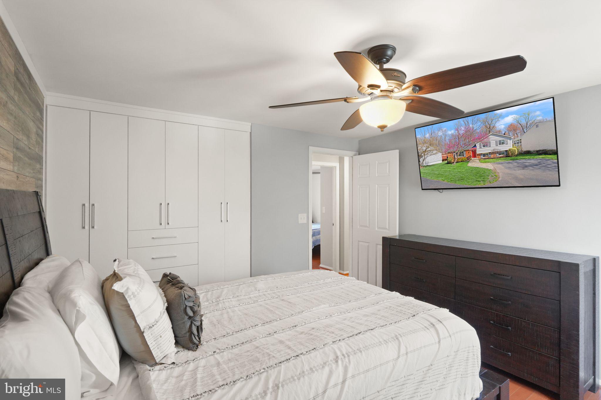 8282 Morning Dew Court Springfield, VA 22153 - Photo 28 of 63 a bedroom with a bed and a painting on the wall