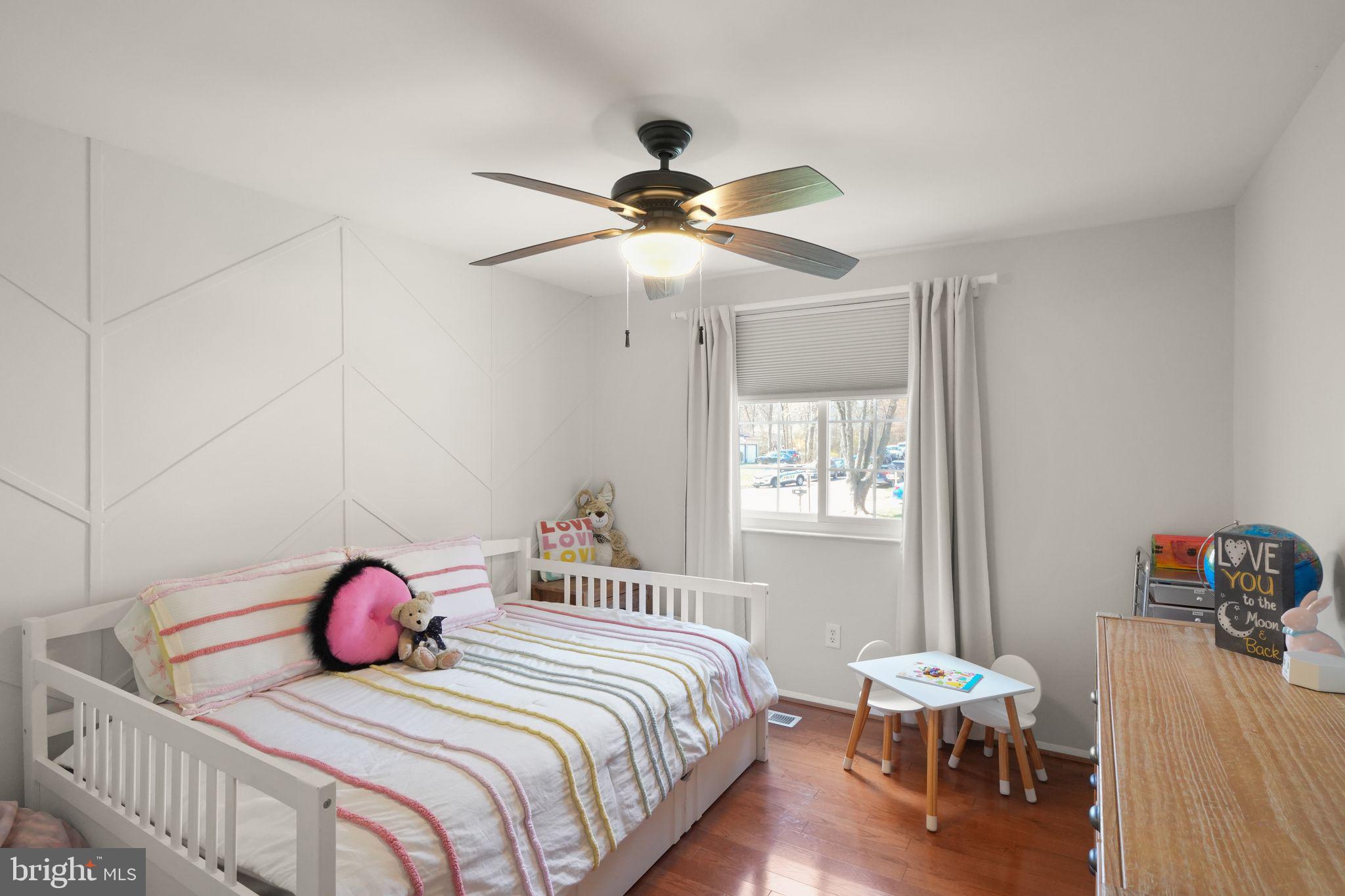 8282 Morning Dew Court Springfield, VA 22153 - Photo 29 of 63 a bedroom with a bed and a chandelier
