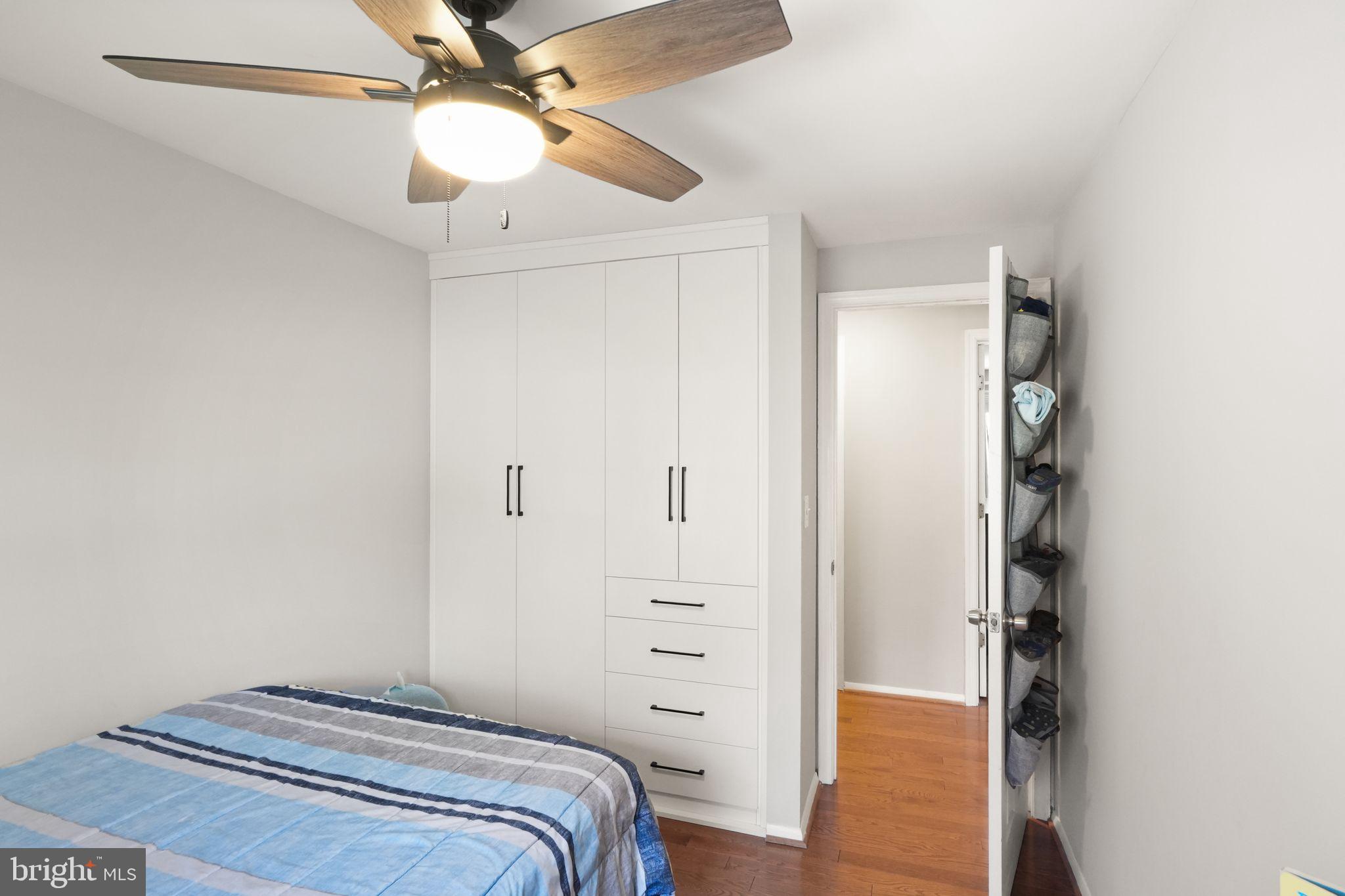 8282 Morning Dew Court Springfield, VA 22153 - Photo 32 of 63 a bedroom with a bed and a chandelier fan
