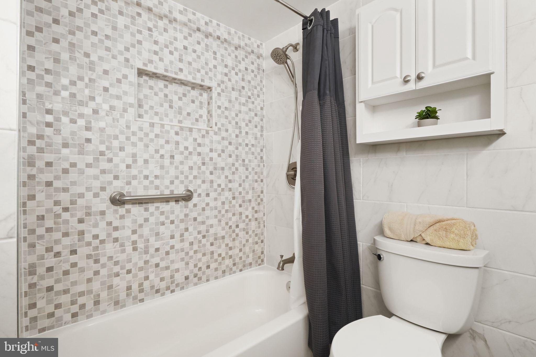 8282 Morning Dew Court Springfield, VA 22153 - Photo 34 of 63 a bathroom with a toilet and a shower curtain