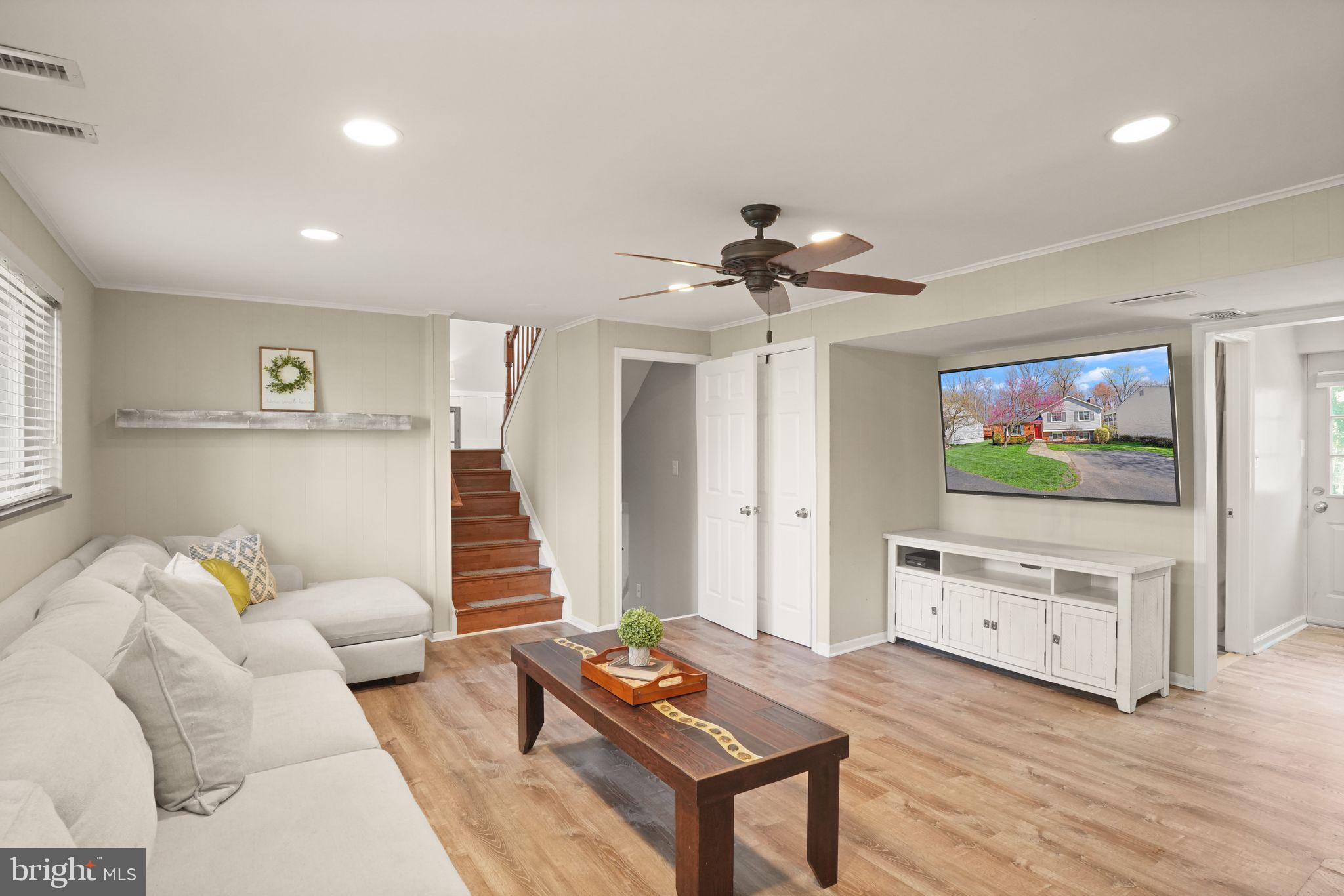 8282 Morning Dew Court Springfield, VA 22153 - Photo 38 of 63 a living room with furniture and a flat screen tv