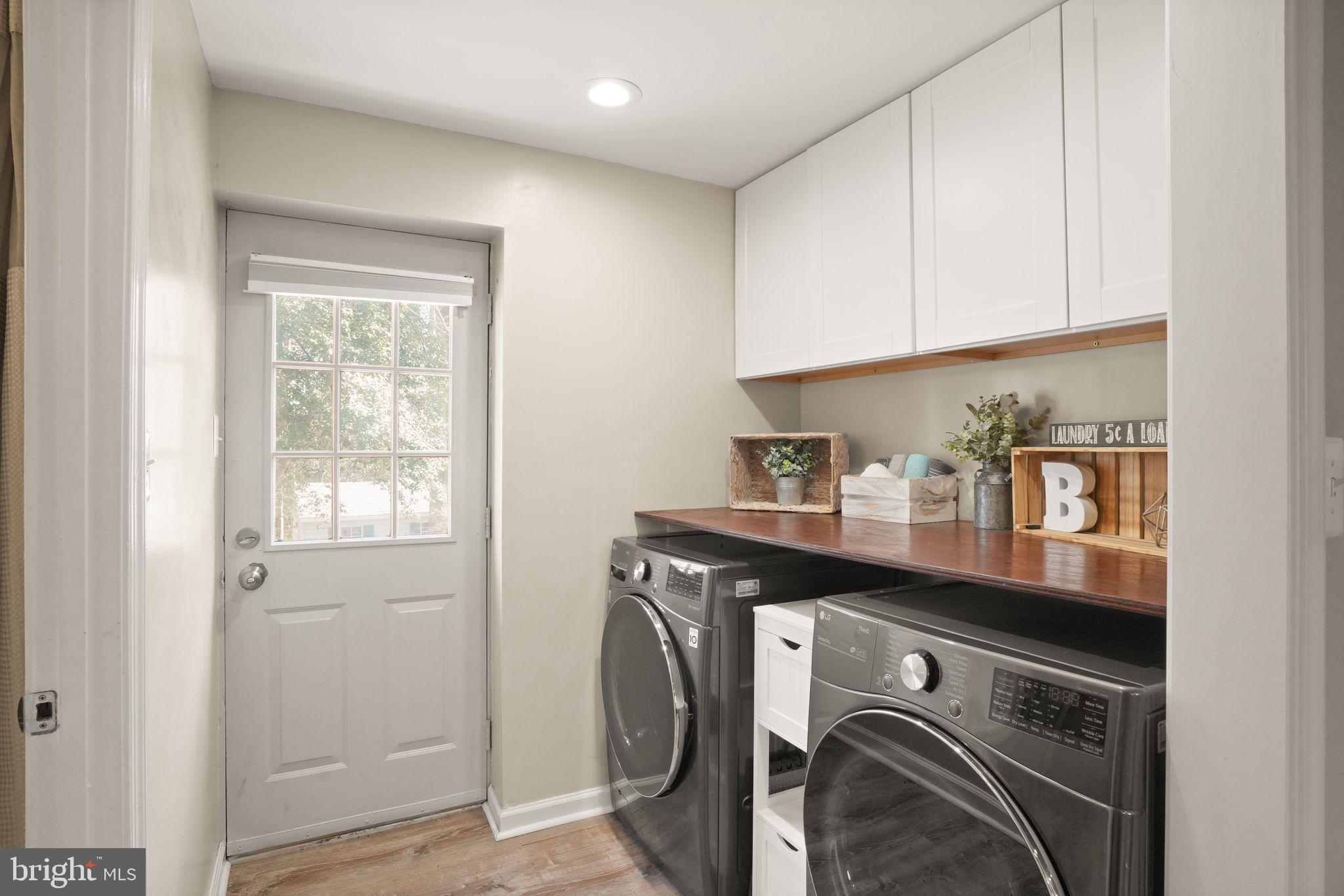 8282 Morning Dew Court Springfield, VA 22153 - Photo 39 of 63 a utility room with cabinets washer and dryer