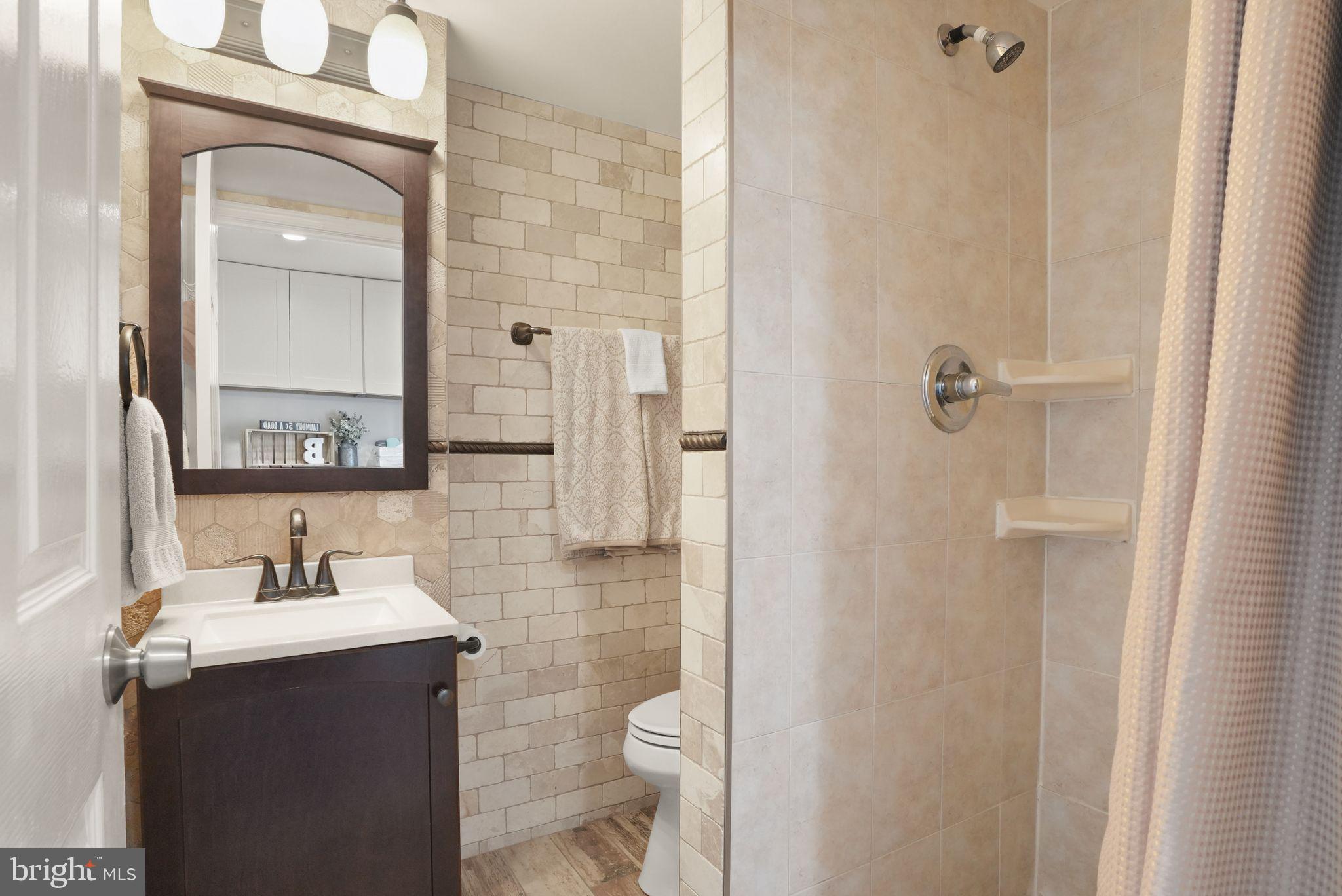 8282 Morning Dew Court Springfield, VA 22153 - Photo 40 of 63 a bathroom with a sink vanity and toilet