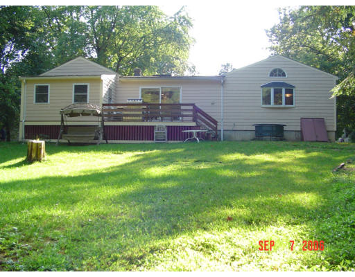62 Prescott Road Concord, MA 01742 - Photo 1 of 25 a front view of a house with a garden and yard