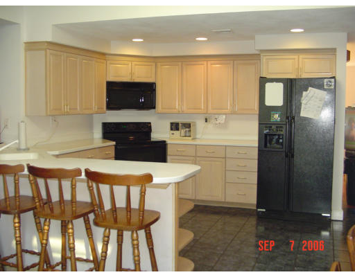 62 Prescott Road Concord, MA 01742 - Photo 2 of 25 a kitchen with a refrigerator and a stove top oven