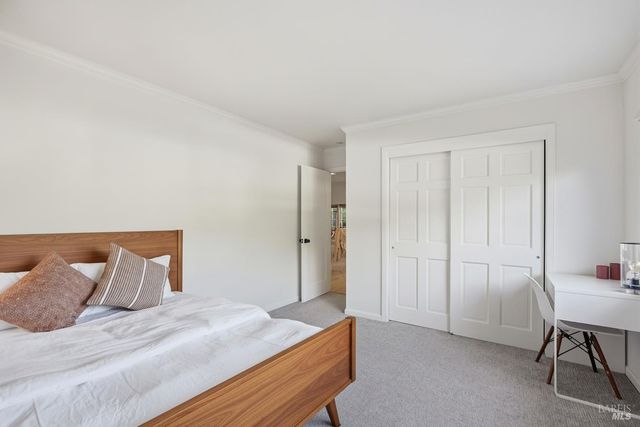 a bedroom with a bed and a table chair