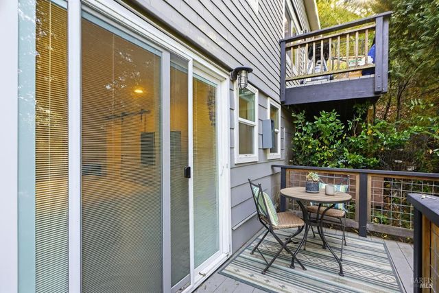 a view of a chairs and table in the balcony