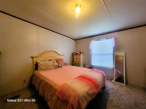 a bedroom with a bed and a night stand