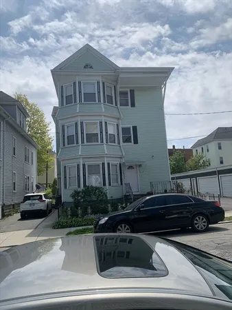 a front view of a house with car parked