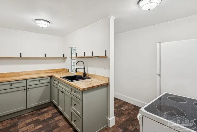 a kitchen that has a sink and a stove