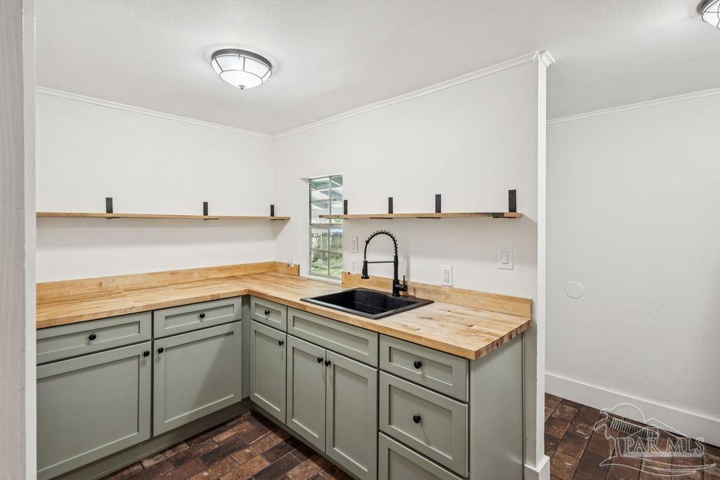 600 East Jackson Street Pensacola, FL 32501 - Photo 15 of 45 a kitchen with a sink and cabinets
