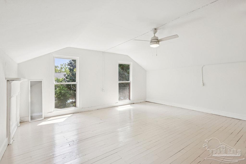 600 East Jackson Street Pensacola, FL 32501 - Photo 18 of 45 an empty room with windows and fan