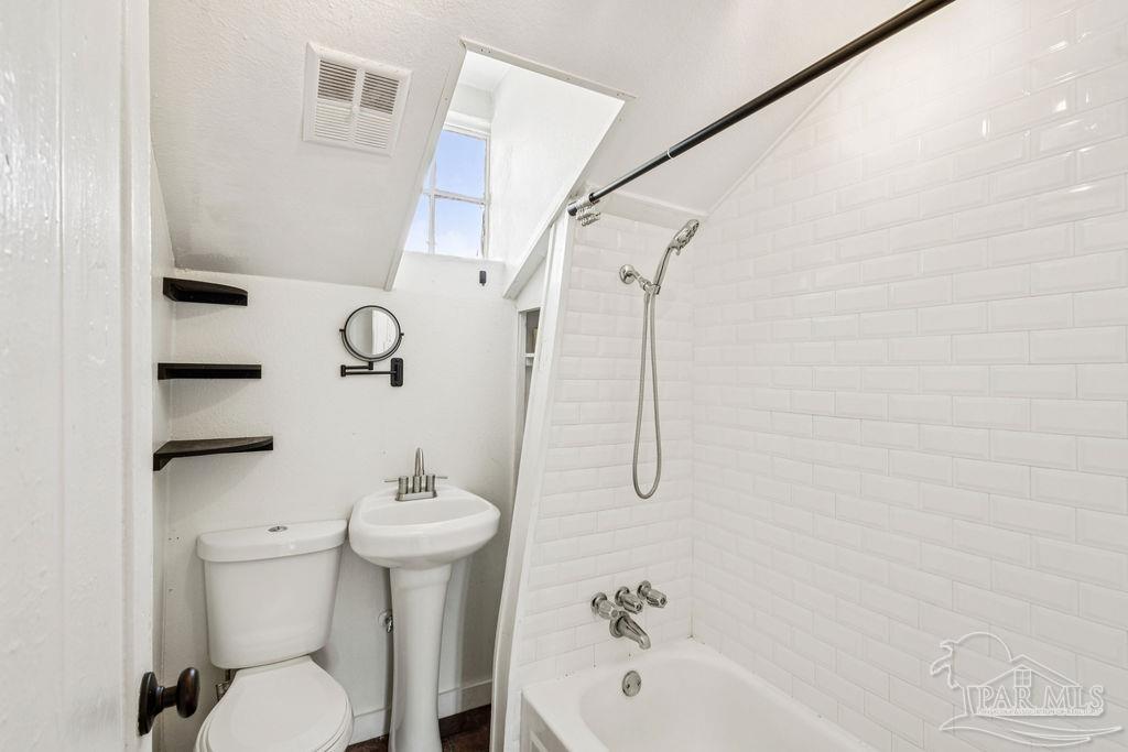 600 East Jackson Street Pensacola, FL 32501 - Photo 22 of 45 a bathroom with a sink a toilet and shower