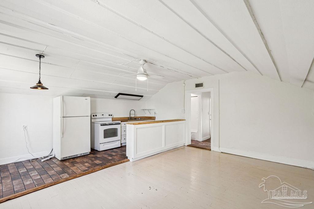 600 East Jackson Street Pensacola, FL 32501 - Photo 24 of 45 a large kitchen with a stove and white cabinets