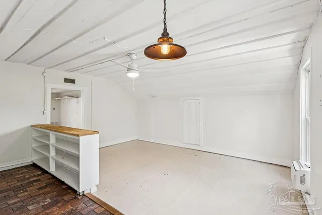 a room with a stove and cabinets