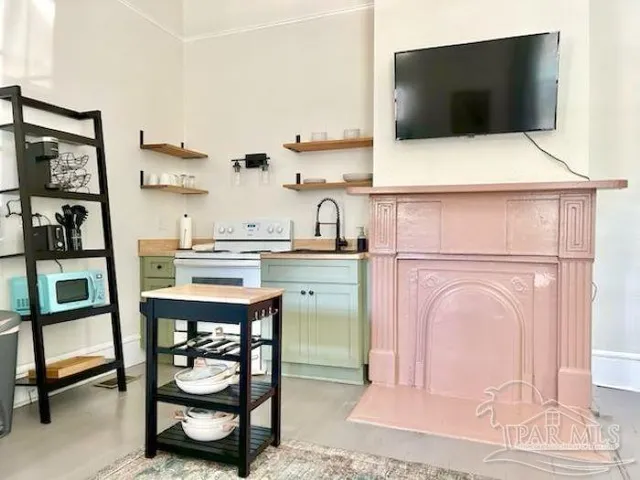 a kitchen with a sink a microwave and cabinets
