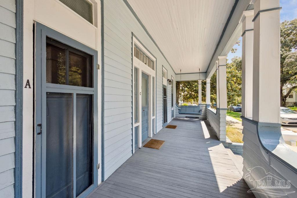 600 East Jackson Street Pensacola, FL 32501 - Photo 3 of 45 a view of a hallway with wooden floor and windows