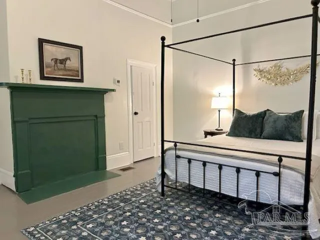 a bedroom with a bed and a painting on the wall