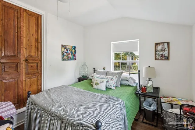 a bedroom with a bed and wooden floor