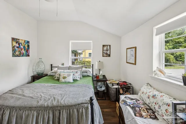 a bedroom with two beds and a window