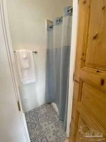 a bathroom with a shower and a sink