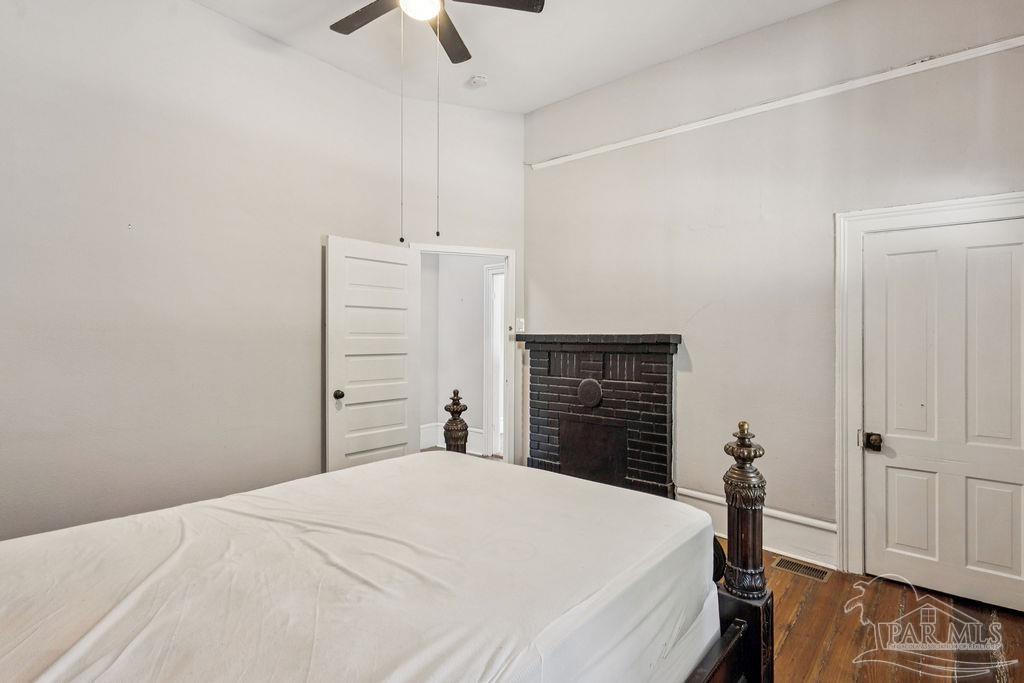 600 East Jackson Street Pensacola, FL 32501 - Photo 10 of 45 a bedroom with a bed and a chandelier