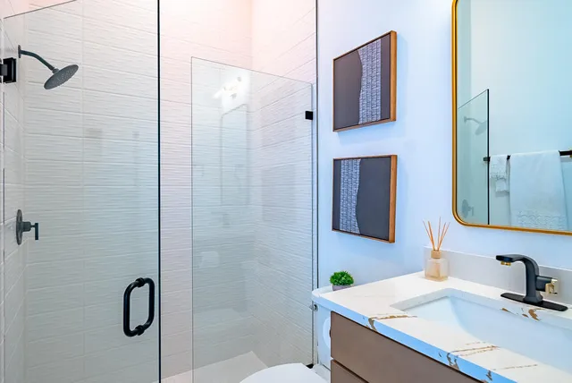 a bathroom with a sink a toilet and a mirror