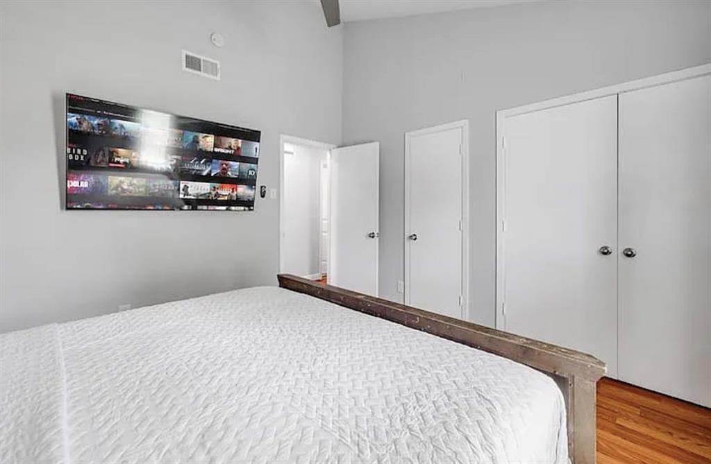 1718 Ripley Street Dallas, TX 75204 - Photo 24 of 33 Hardwood-style flooring, white paneled doors, and light gray wall paint